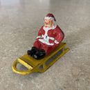 Santa Claus on Yellow Sled Lead Figure.