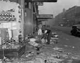 Damaged dummies are strewn outside this wrecked store on West 125t .. Old Photo