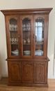 Antique tall mahogany dresser. Displays items beautifully behind glass doors.