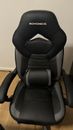 Used Songmics leather gaming chair, black color with headrest.